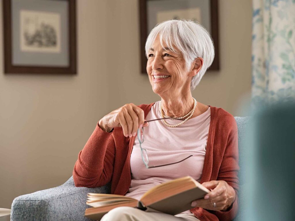 Smiling older woman with a book