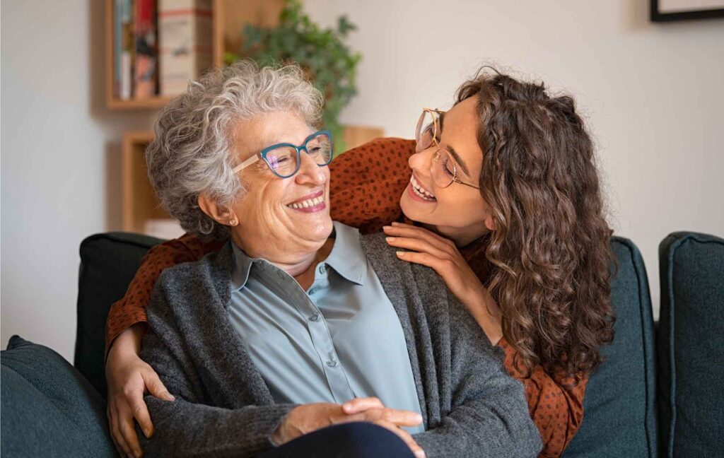 Happy Latinx women smiling at each other