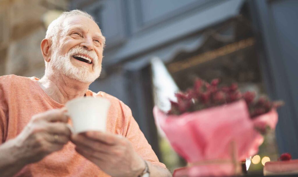 Smiling older man with cup of coffee