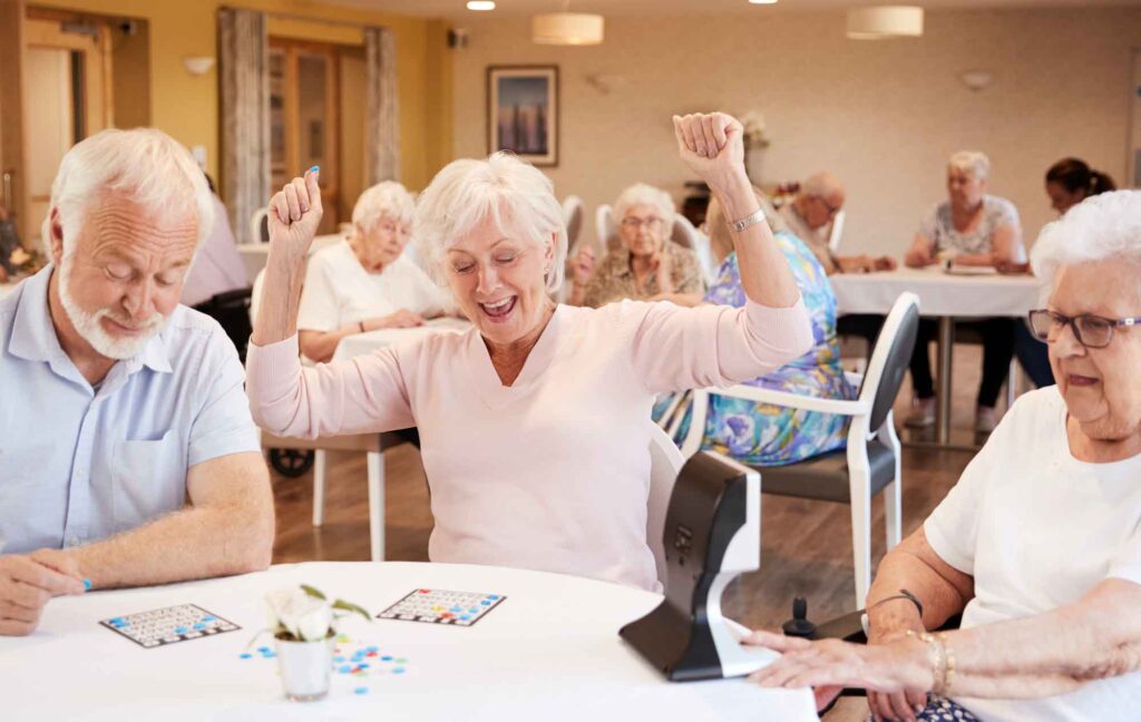 Senior woman winning at Bingo and playing Bingo with friends